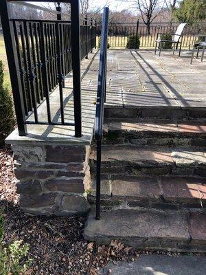 Raised fieldstone terrace and steps, topped with random bluestone, custom railing.