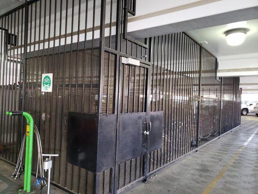 Bike parking in actual parking structure.  Wild AF.  Used to be in a cage behind the hospital near an HVAC intake.