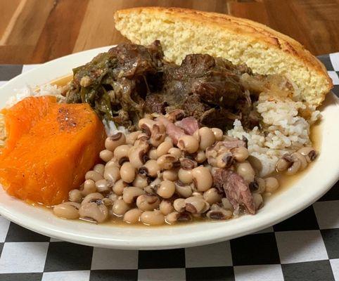 tender oxtails over rice, black-eyed peas, candied sweet potatoes, cornbread