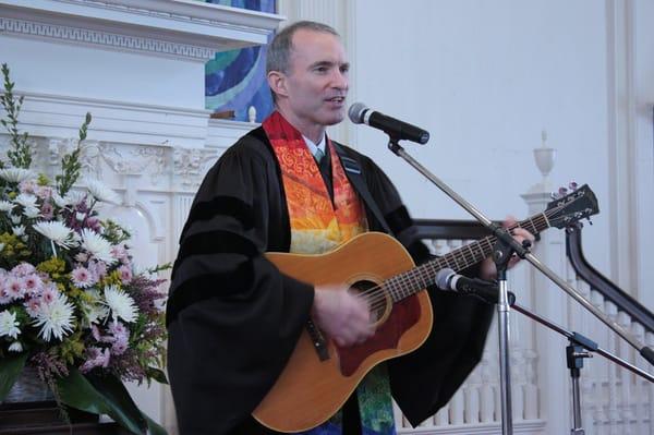 Senior Minister Rev Fred Small leading a song during Sunday worship