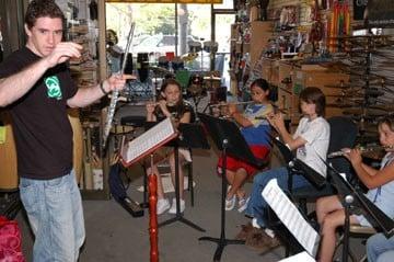 Conducting my students in an ensemble piece for a performance at the local music store, The Magic Flute.