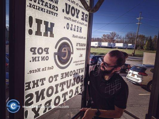 Brian installing our door graphic!