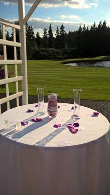 View in area directly outside of the dining area, overlooking the golf course.  Set up for wedding's sand unity ceremony.