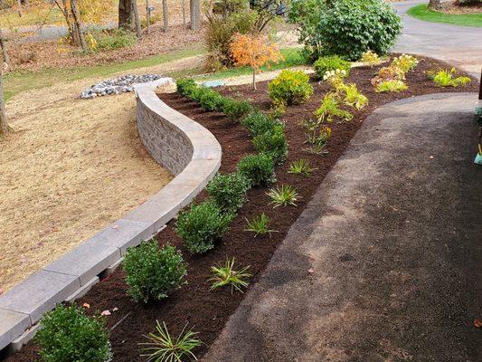 Retaining wall installation with landscape design