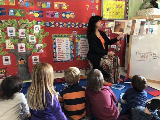 Listening to Teacher Linda read a book.