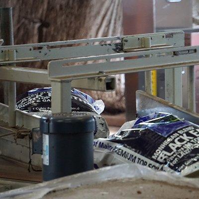 Coast of Maine's Monhegan Blend, Black Earth soil on the bagging line