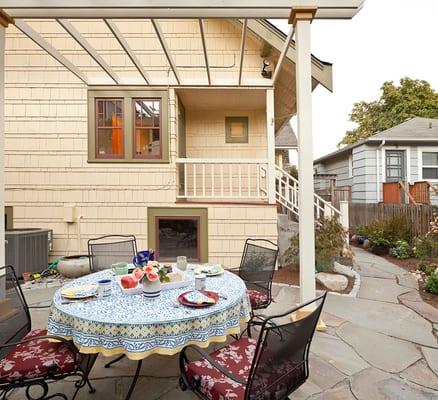 Sand-set bluestone was selected as the pathway and  patio material to stay in keeping with the Craftsman style of this home.