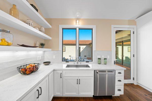 open shelves in the kitchen are a beautiful way to display cherished pieces. This home is located in Palos Verdes.