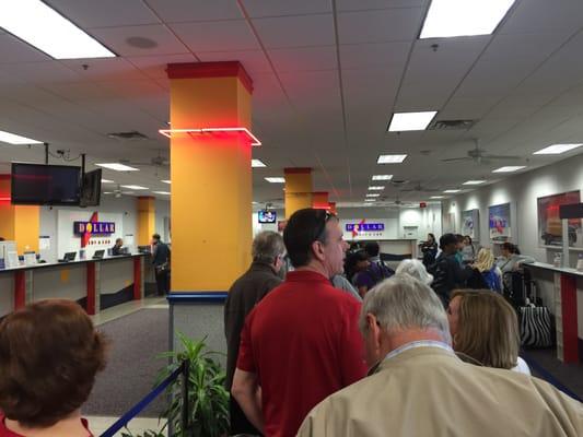 Don't use Dollar Car Rental in Sanford. Long line of people waiting, one employee at the counter.