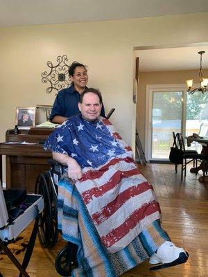 Sandra giving a client a gentleman haircut in his home