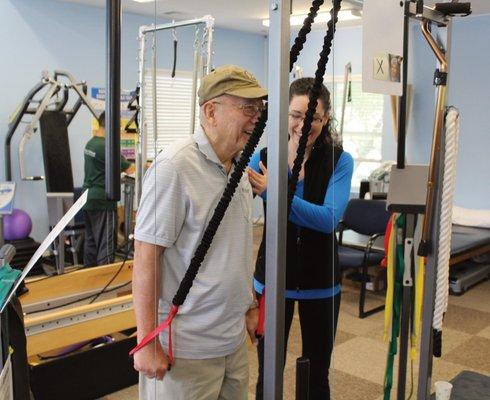 Our occupational therapist Laura helping a patient with arm strengthening exercises