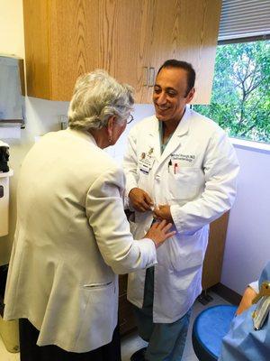 Dr. Vosoghi welcomes a long time patient to his office.