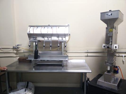 Wine bottling machine with corking machine.