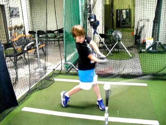 Jack getting his swing right with one of our top notch instructors!