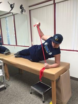 High school football player performing high-level shoulder stabilization exercises following shoulder dislocation injury