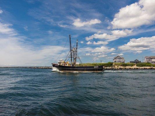 Fishing boat heading out to sea