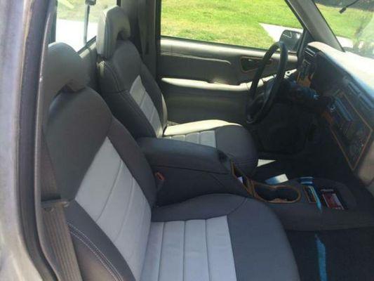 We custom upholstered this 2000 s10 with white leather inserts and grey vinyl. We also replaced the carpet and headliner