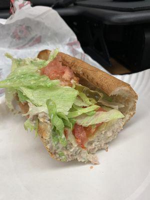 Half of my small tuna sub with lettuce tomato and pickles. Toasted