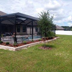 Newly installed retaining wall, mulch and plants.