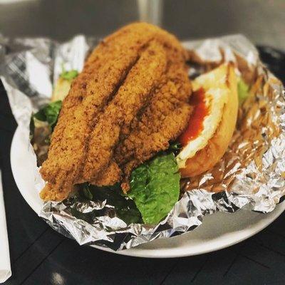 Toasted bread, fully dressed, and catfish cooked perfectly. Fish seasoned so well no sauce is needed! Catfish Poboy for the win!