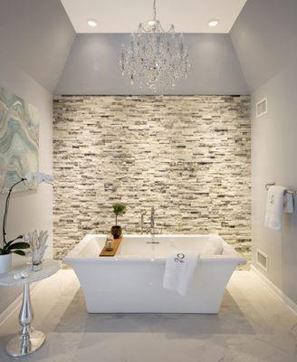 Designed to replicate a spa experience, this luxurious tub room complements separate his and hers bathrooms with skylights.