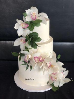 Buttercream wedding cake w/ fresh cascading orchids