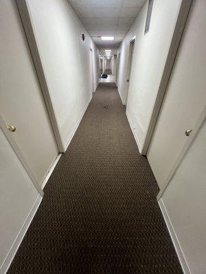 Two females sleeping in the hallway