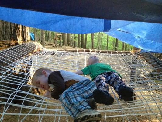 Kid trying out rope beds made at Woodcraft Summer Camp.