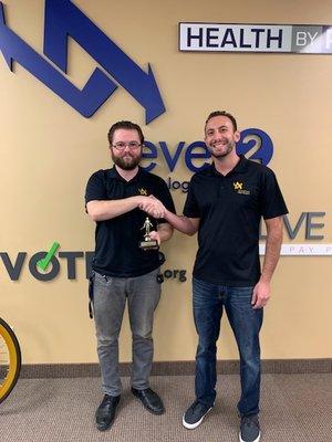 Our valued employee Billy receives a "Ticket Slayer" award from President Daniel.