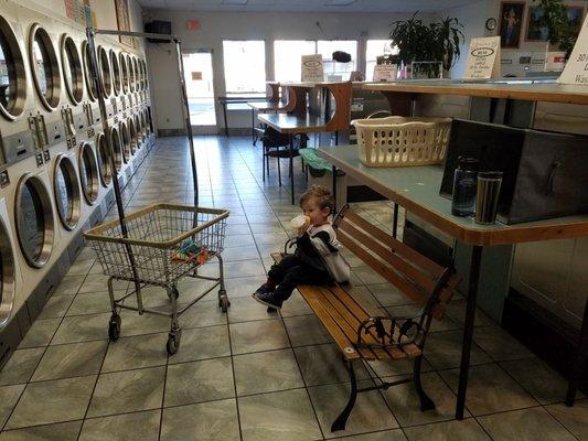 My son drinking some milk while our clothes dry.