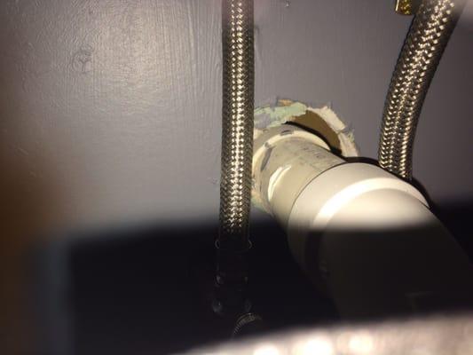 Holes in walls at back of vanities where pipes enter wall