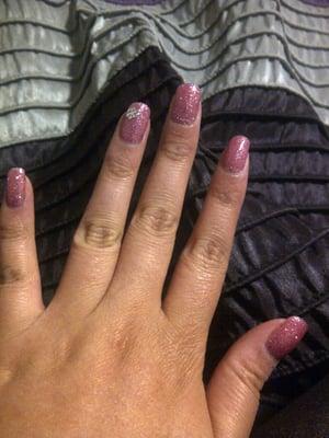 Pink shellac manicure with pink glitter and flower jewel design