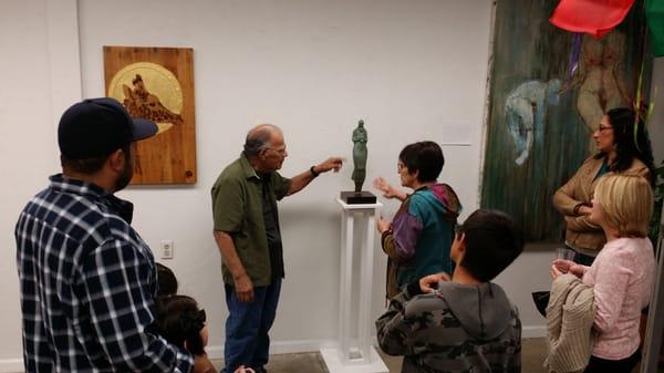 Artist Armando Baeza sharing his bronze sculpture in the gallery