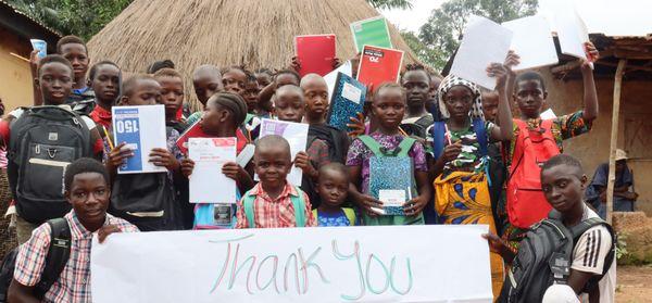 Village kids with donated school supplies