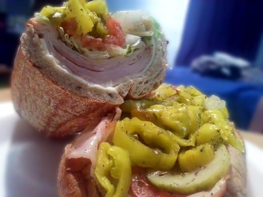 smoked turkey hoagie on a wheat roll with extra meat and the works . its a beautiful thing