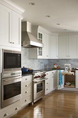 Stainless appliances and hood with white painted cabinetry is a popular choice when renovating a kitchen.