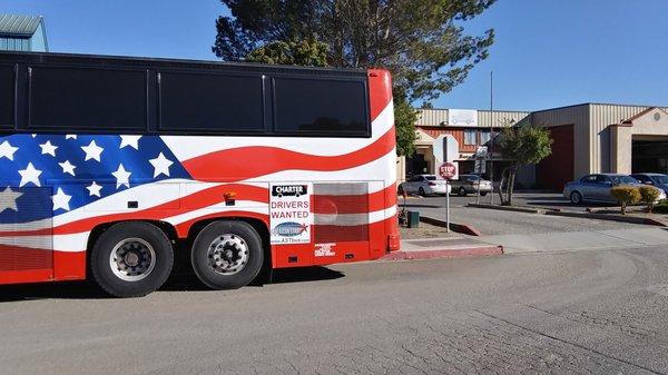 bus parked in front of a rival company in a petty response to losing a school contract to a better company.