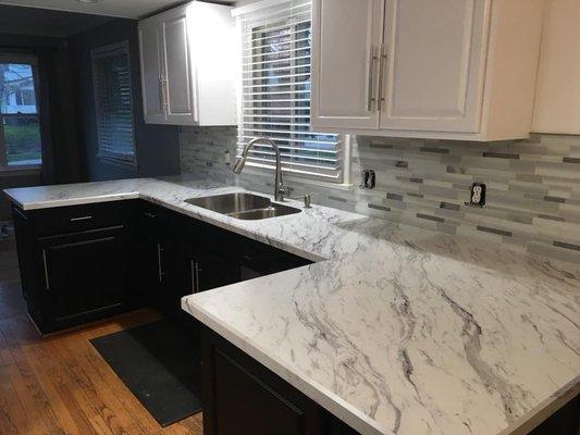 Peninsula Bevel edge top color Calcutta Marble with a Karran under mount sink.