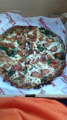 Wheat crust with pesto sauce, chicken sausage, sun dried tomatoes,  and spinach..Yummy!