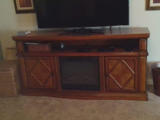 Solidly built tv stand with fireplace.