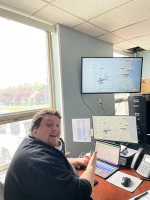 Our lead dispatcher, John, showing us how he tracks each delivery.