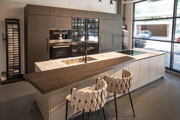 Pedini oak veneer tall cabinet units, base cabinets matte lacquer, countertop Dekton in Bergen Stonika, Miele appliances