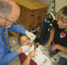 Dr. Thompson engages mom and child in the work!