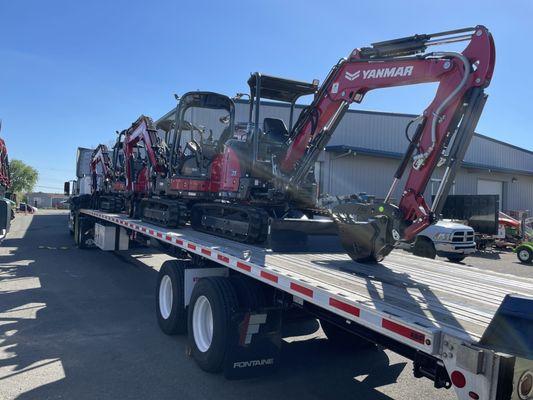 Truckload of new Yanmar mini excavators leaving the yard.