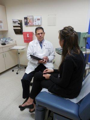 Dr. Joseph Gordon, General Surgery, talking to a patient.