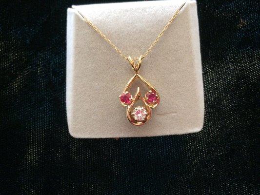 14 karat yellow gold, .29 carat GH VV2 diamond, ruby pigeon red color, custom made piece.