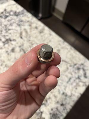 Old drain plug with the worn out washer that was not changed (you can see the debris on the washer still)