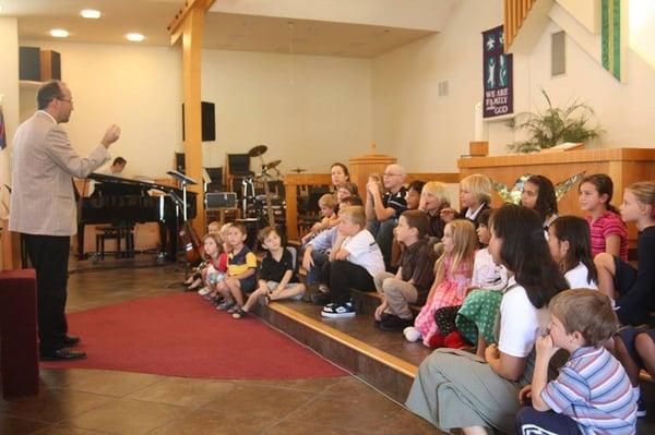 Pastor Kevin Schultz shares a message with the children