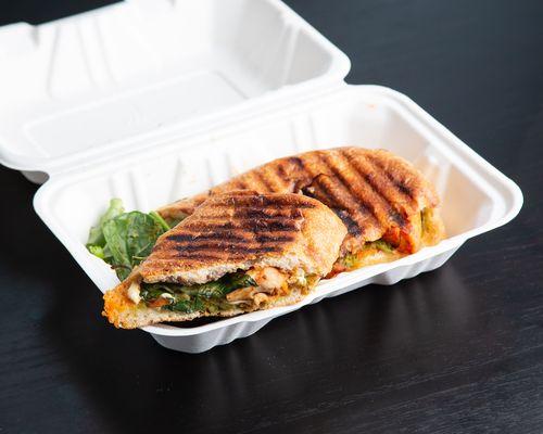 Customer favorite - Pesto Chicken Melt: local ciabatta, pasture-raised chicken, pesto (seed based), spinach, balsamic glaze, pressed