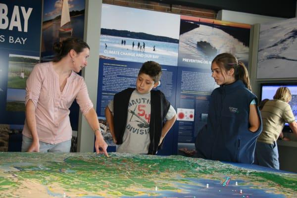 Volunteers guide visitors through the features of the Ba Learning Center